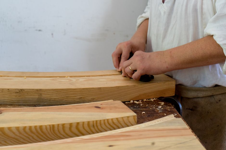 Master woodworker crafting cabinets in a workshop